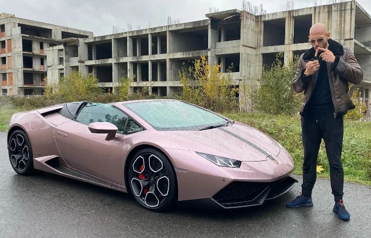 Andrew Tate poses with his Lamborghini